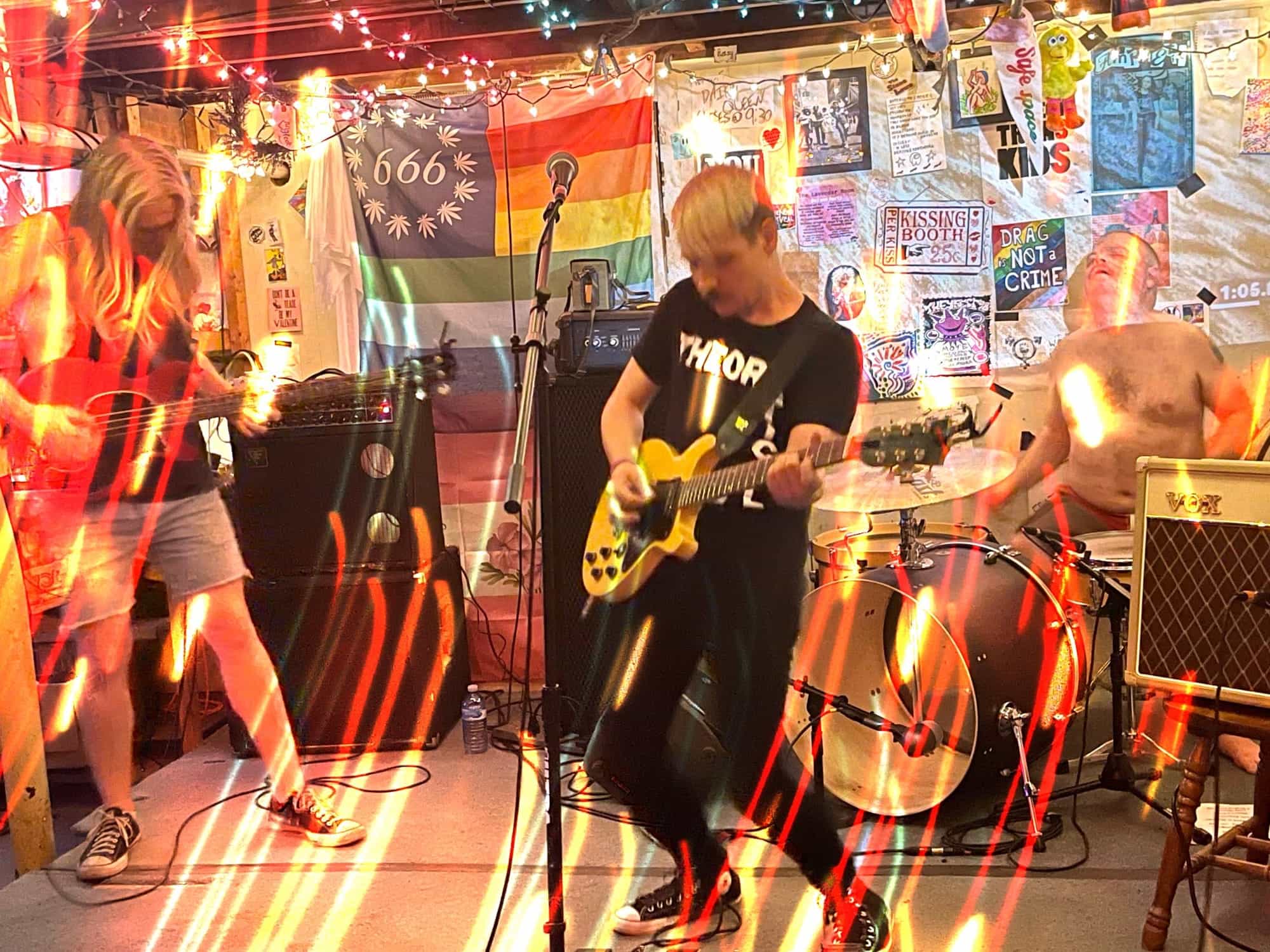 a photo of Neon Fantastic rocking out at The Lavender Room with lights blurring in swirls around them as if someone is turning the camera